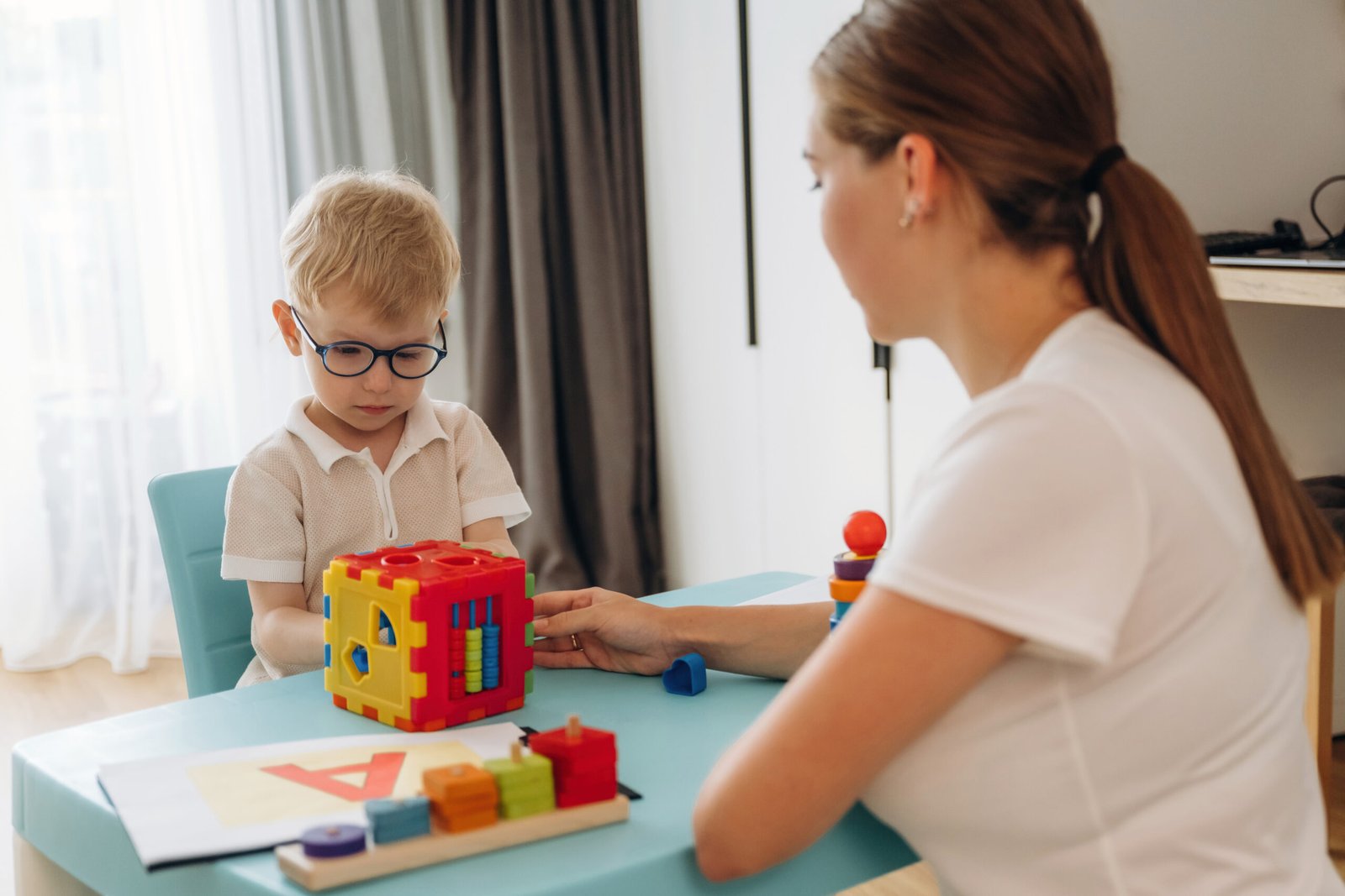 Adult supporting a child during play-based activity